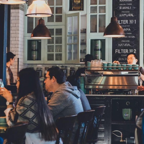 Bustling community with plenty of dining choices a group of people in a restaurant